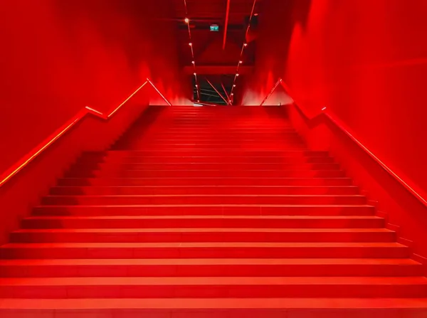 Red steps leading up. Red interior  background, horizontal image.