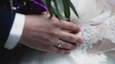 A holding hands together close up of just married couple
