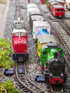 Kırmızı elektrik model tren lokomotif ve düzeni ile bir istasyon ve özelliklerle tüm sahneyi kümesi.