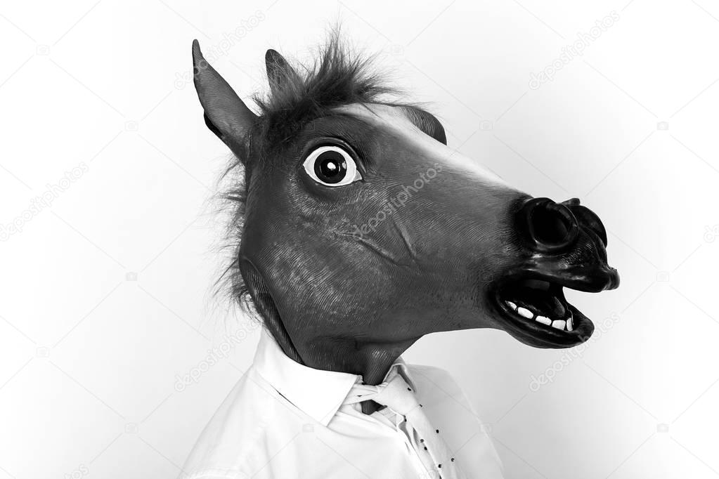 Businessman closeup portrait wearing horse head black and white