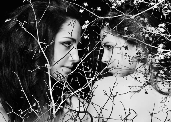 Monochrome double exposure of girls looking at other and branches — Stock Photo, Image