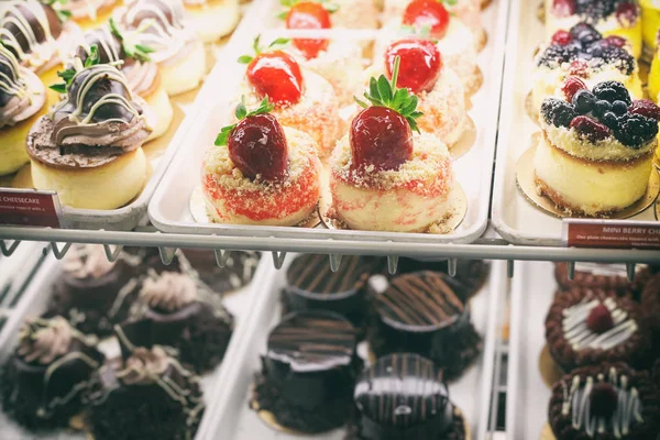 Beautiful and delicious mini cakes in pastry shop — Stock Photo, Image