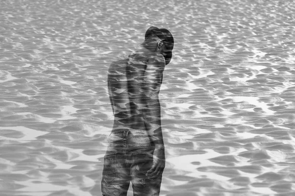 Double exposure of african man back portrait and sand pattern