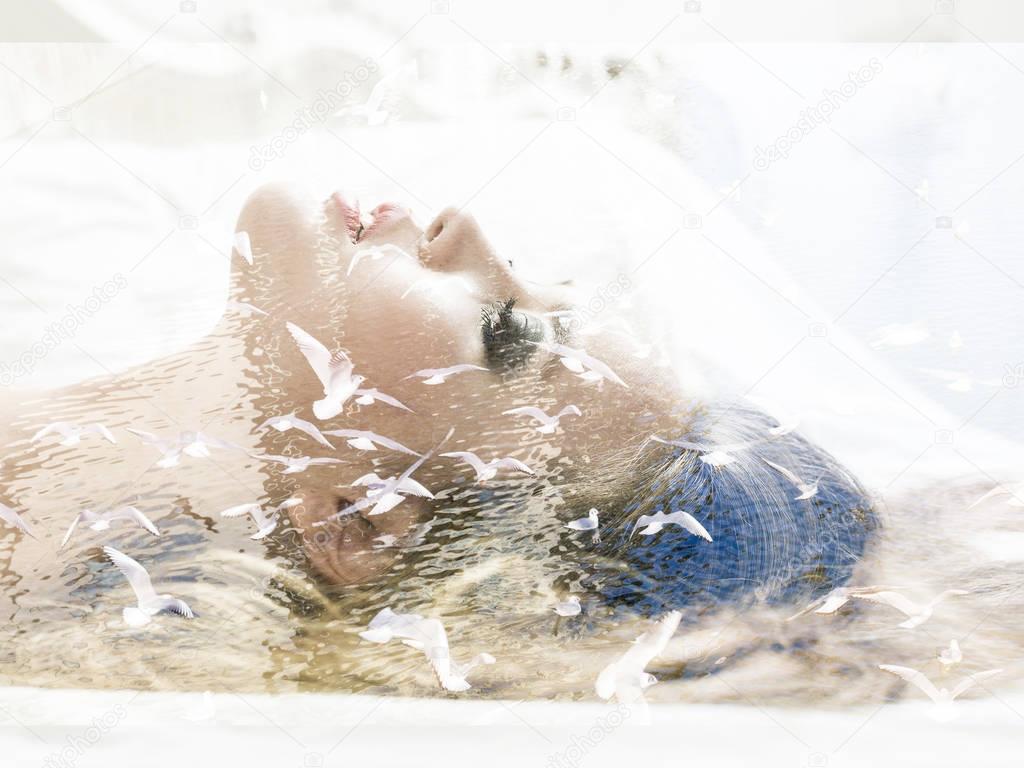 Double exposure of woman lying in bed and seagulls flying