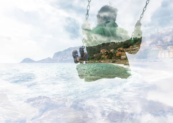 Double exposure of kid on swing and sea city coast — Stock Photo, Image