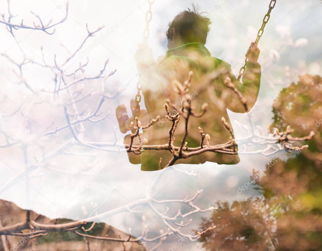 Double exposure of kid on swing and autumn tree branches