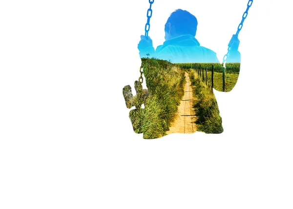 Double exposure of kid on swing and path in countryside — Stock Photo, Image