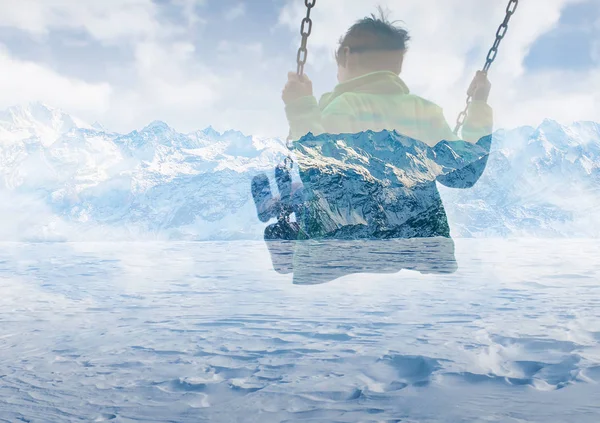 Double exposure of kid on swing and gorgeous snowy mountainscape — Stock Photo, Image