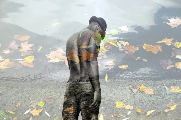 Double exposure of african man back portrait and autumn leaves