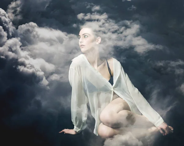 Double exposure of beautiful and thoughtful girl and stormy cloudscape — Stock Photo, Image