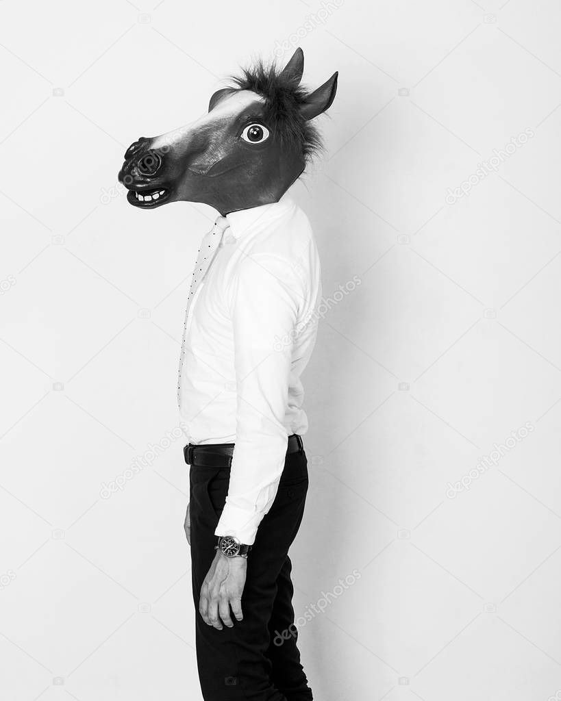 Businessman portrait wearing horse head black and white
