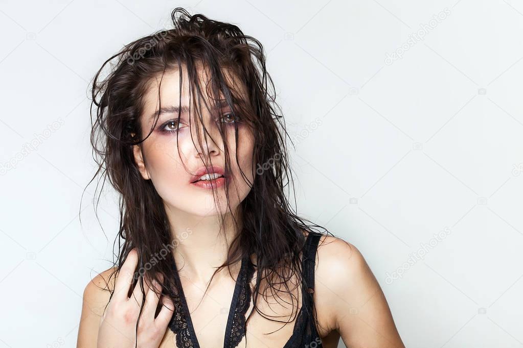 Gorgeous woman portrait with wet hair and smudged makeup looking
