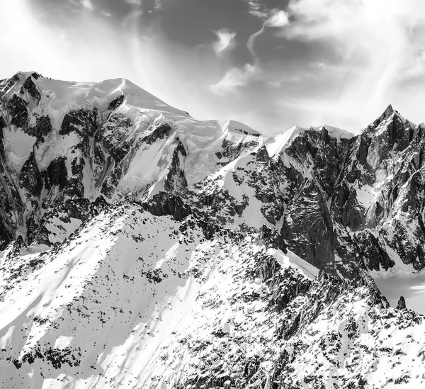 Beautiful snowy mountain peaks in North Italy and cloudscape monochrome — Stock Photo, Image