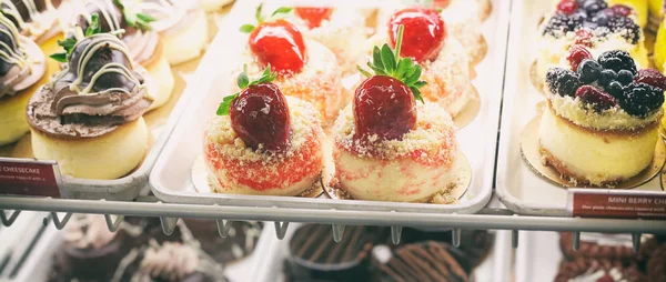 Beautiful and delicious mini cakes in pastry shop letterbox — Stock Photo, Image