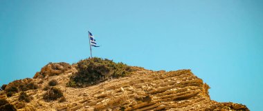 Rock Peyzaj ve mavi gökyüzü ile Yunan bayrağı mektup