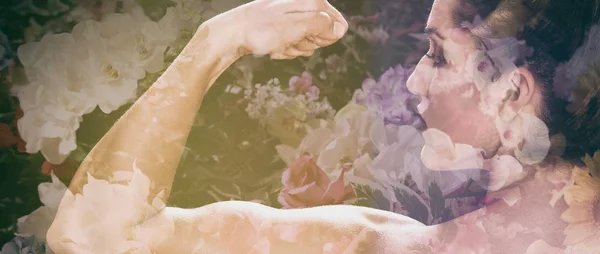 Letterbox double exposure of female bodybuilder showing muscles and flowers — Stock Photo, Image