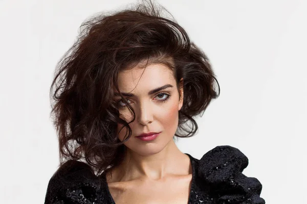 Woman with messy hair looking at camera and wearing sequin dress — Stock Photo, Image