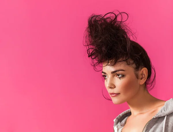 Woman portrait with messy bun wearing hoodie and looking aside — Stock Photo, Image