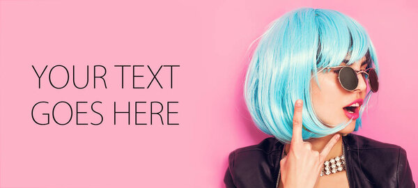 Pop girl portrait wearing blue wig and making the horns, card