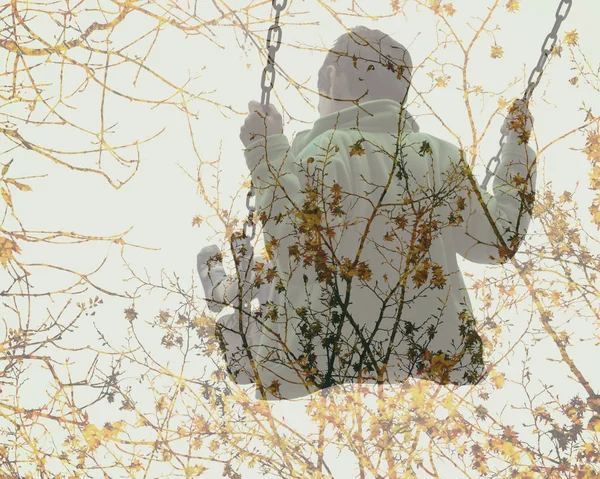 Multiple exposure of kid on swing and autumn tree branches