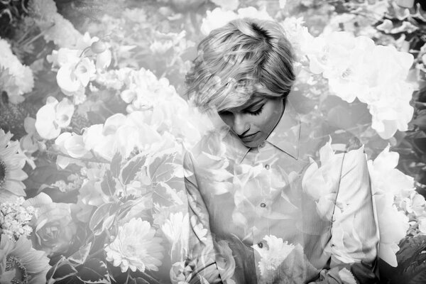 Monochrome double exposure of beautiful thoughtful girl and lot of flowers