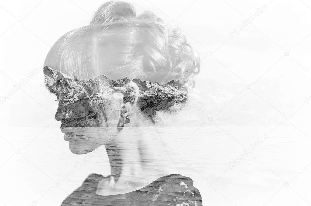 Monochrome double exposure of woman profile portrait and snowy mountains