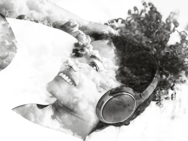 Monochrome double exposure of smiling woman listening to music a — Stock Photo, Image