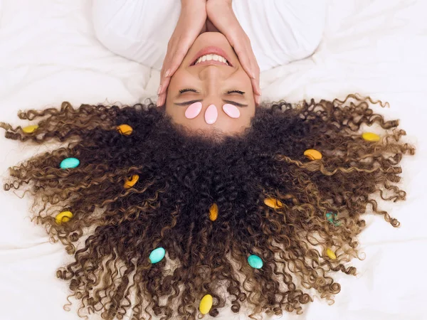 Beautiful woman portrait with sugared almonds in her hair — Stock Photo, Image