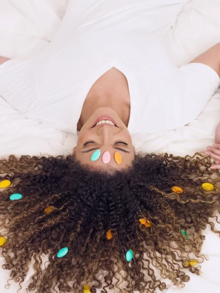 Lovely and happy woman portrait with sugared almonds in her hair — Stock Photo, Image