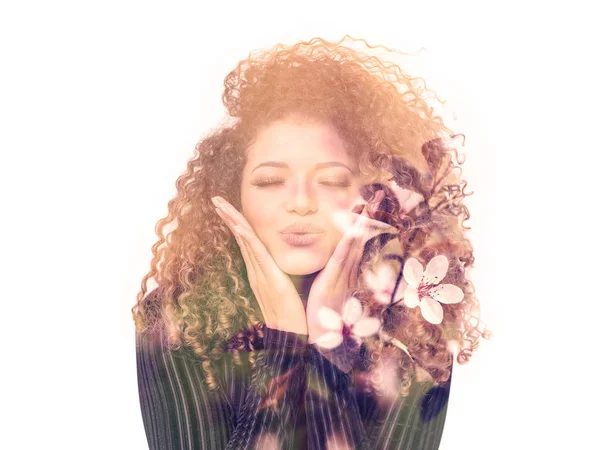 Double exposure of lovely woman giving kiss and beautiful cherry blossoms — Stock Photo, Image