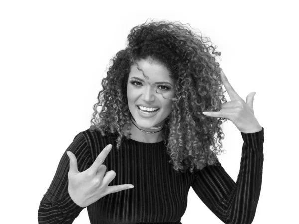 Rocker woman with gorgeous curly hair making the horns, monochrome — Stock Photo, Image
