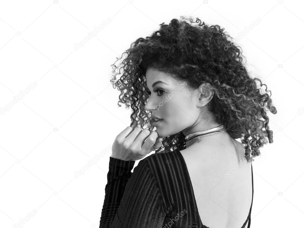 Beautiful woman back portrait with gorgeous curly hair, black and white