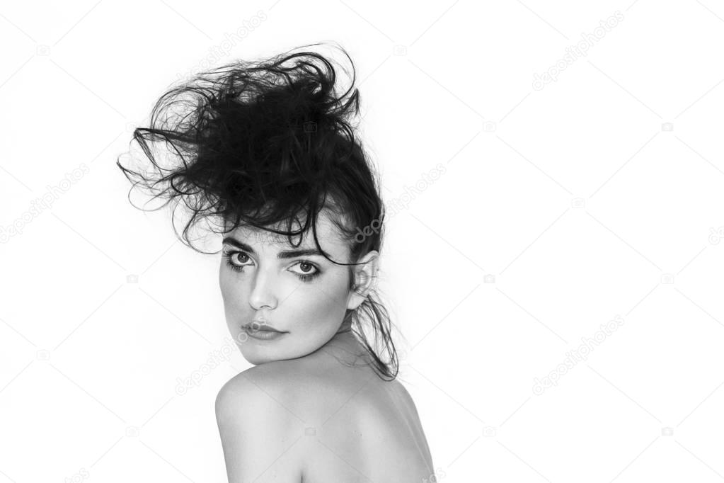 Pretty woman portrait with messy hair and smudged makeup, black and white