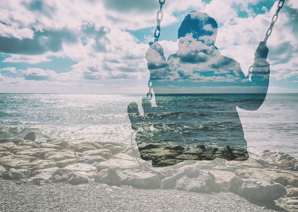 Double exposure of kid on swing and gorgeous seascape and cloudscape — Stock Photo, Image