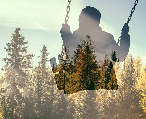 Double exposure of kid on swing and pine wood in Autumn — Stock Photo, Image
