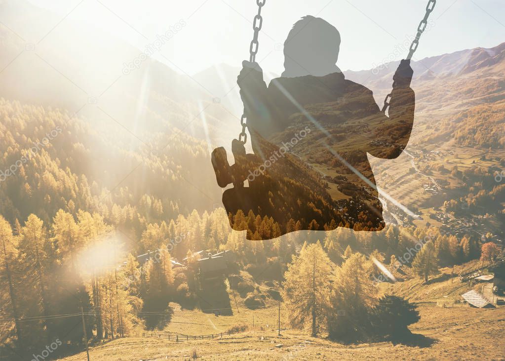Double exposure of kid on swing and autumnal mountain view