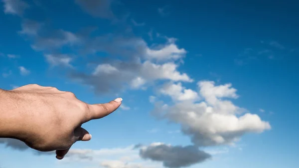 Human finger pointing at cloud in the sky — Stock Photo, Image