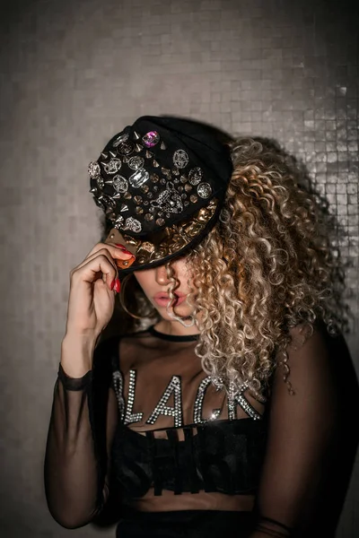 Beautiful woman portrait with gorgeous hair wearing hip hop cap — Stock Photo, Image