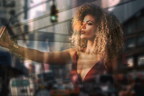 Double exposure of beautiful woman portrait taking selfie and blurred cityscape — Stock Photo, Image