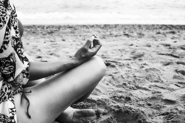 Woman detail portrait meditating on the beach in front of seashore, monochrome — Stock Photo, Image