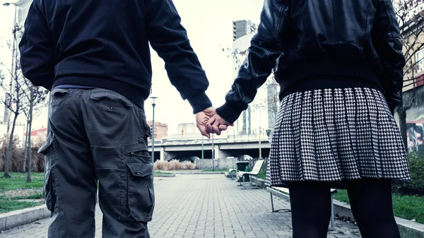 Beautiful couple back portrait holding hands in the city — Stock Photo, Image