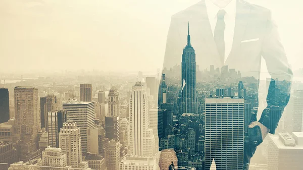 Double exposure ob businessman with hand in pocket and city skyline — Stock Photo, Image