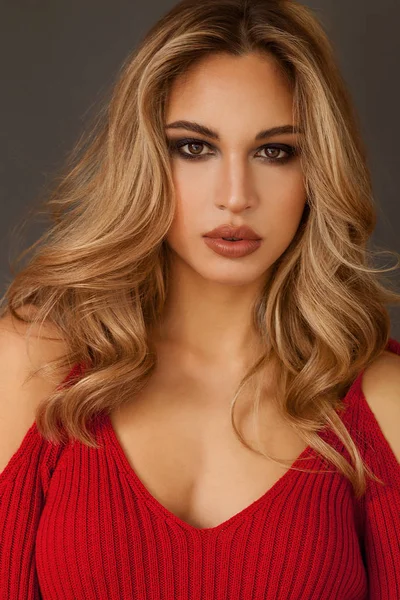 Gorgeous blonde woman portrait with brown eyes wearing red dress — Stock Photo, Image