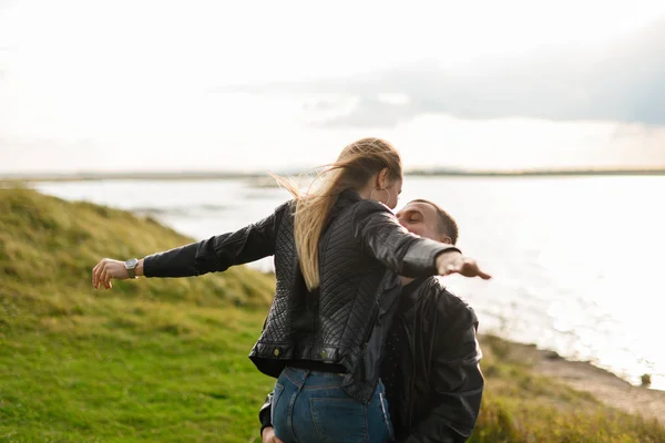 a man circles a woman in his arms