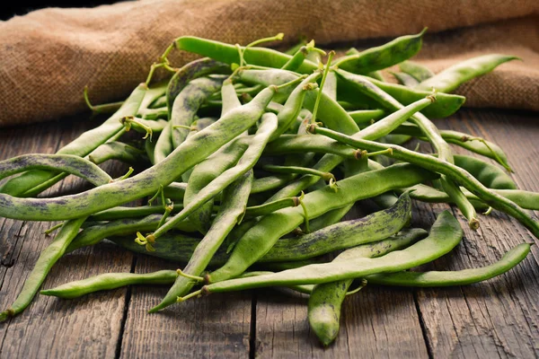 Green beans pods on a wooden table