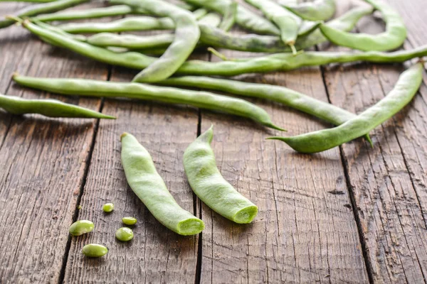 Green beans pods on a wooden table