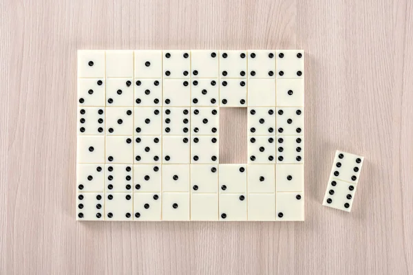 Playing dominoes on a wooden table