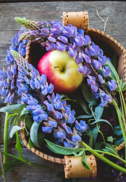 basket with apples and flowers