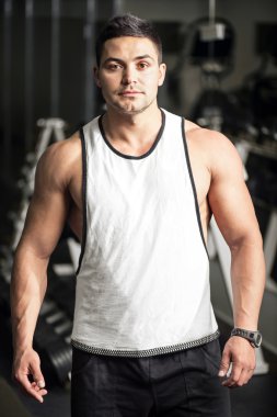 Young well built man training in a gym