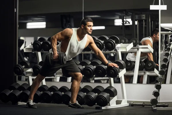 Keményen dolgozó sportos férfi képzés a súlyzó — Stock Fotó